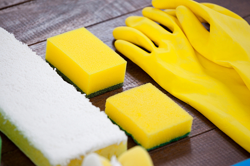 Set of cleaning equipment arranged on wooden floor