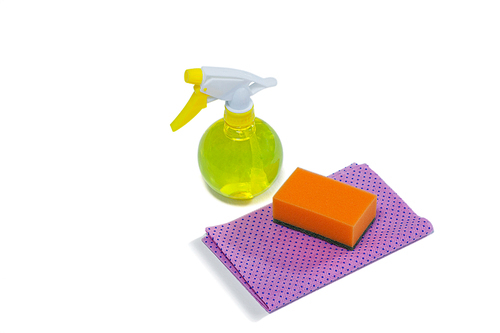 Cleaning spray bottle, sponge and cloth on white background