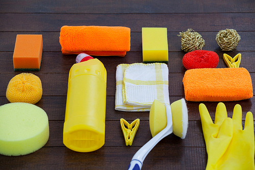 Set of cleaning equipment arranged on wooden floor