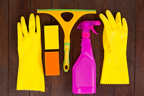 Set of cleaning equipment arranged on wooden floor