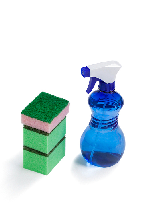 Cleaning spray bottle and stack of scrubber on white background