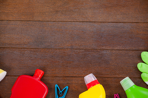 Overhead view of various cleaning equipments arranged on wooden floor