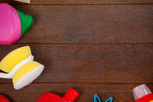 Overhead view of various cleaning equipments arranged on wooden floor