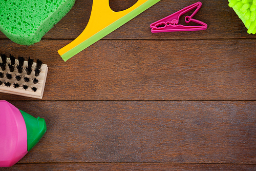 Overhead view of various cleaning equipments arranged on wooden floor