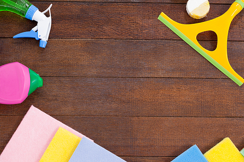 Various cleaning equipments arranged on wooden floor