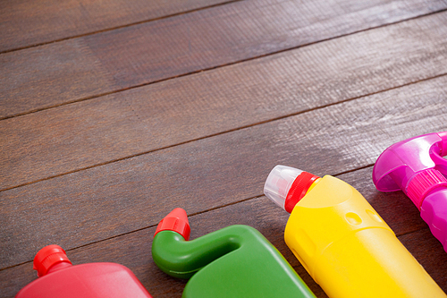 Various detergent bottles arranged on a wooden floor