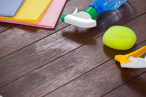 Various cleaning equipments arranged on wooden floor