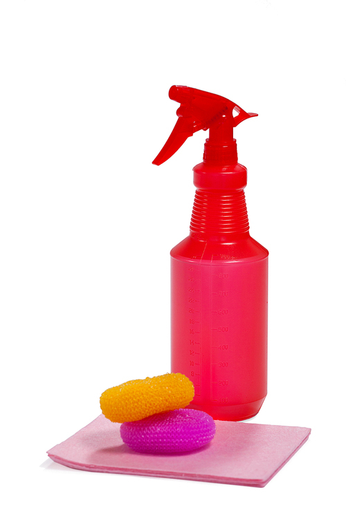 Spray bottle, scrubbers and cleaning pad arranged on white background