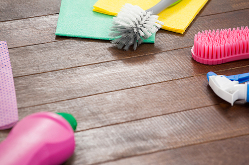 Various cleaning equipments arranged on wooden floor