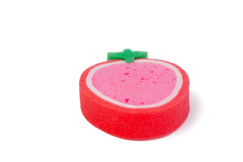 Close-up of strawberry shaped scouring pad on white background