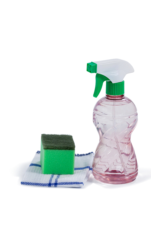 Spray bottle, scouring pad and napkin cloth arranged on white background