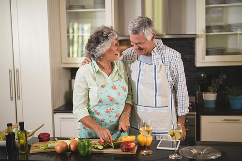 Senior couple preparing food in kitchen at home