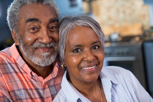 Close up portrait of smiling couple in kitchen at home