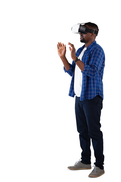 Man gesturing while using virtual reality headset against white background