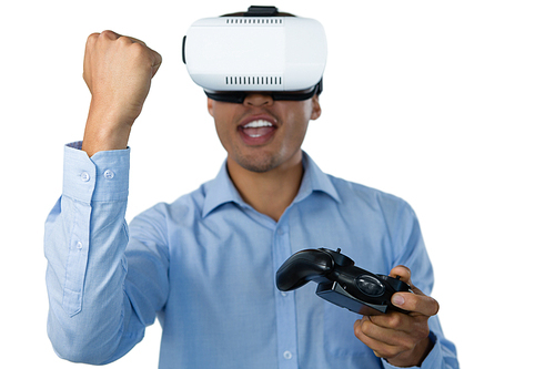 Businessman with vr glasses clenching fist while playing video game against white background
