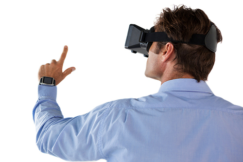 Rear view of businessman gesturing while using vr glasses against white backgrond