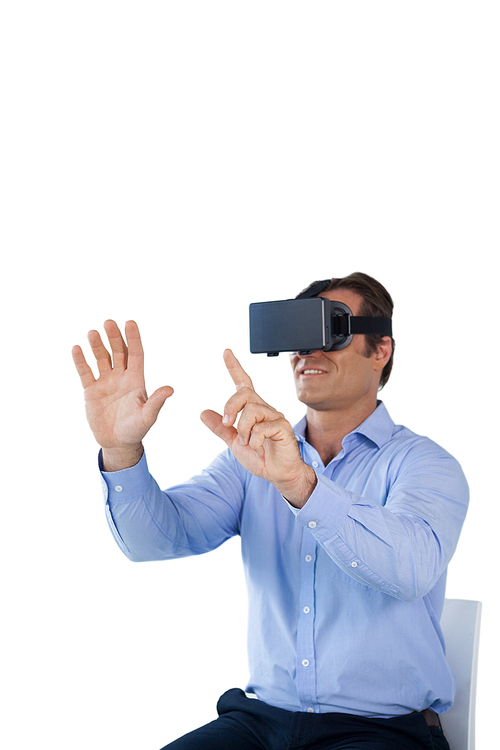 Businessman using vr glasses while sitting on chair against white background