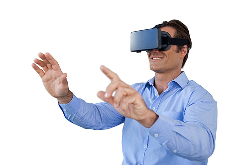 Happy businessman gesturing while wearing virtual reality simulator against white background
