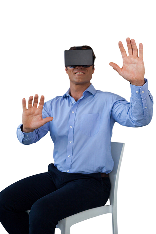 Businessman sitting chair while wearing vr glasses against white background