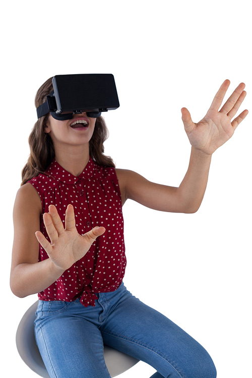 Teenage girl using virtual reality headset against white background