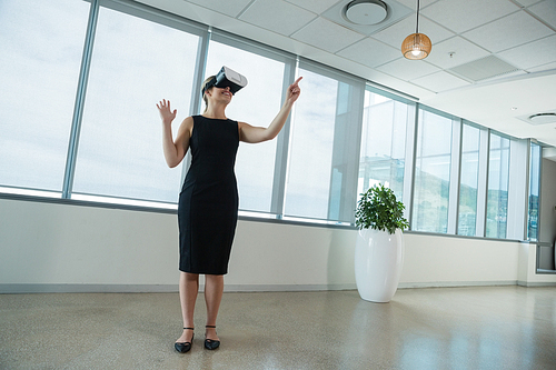 Young female executive using virtual reality headset in office