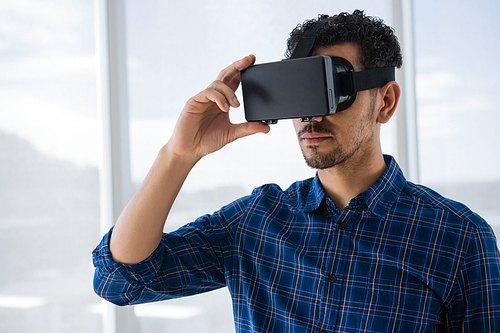 Executive using virtual reality headset in office