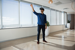 Executive using virtual reality headset in office