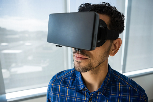 Close-up of executive using virtual reality headset in office