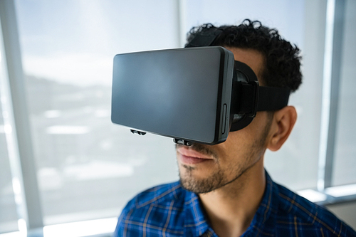 Close-up of executive using virtual reality headset in office