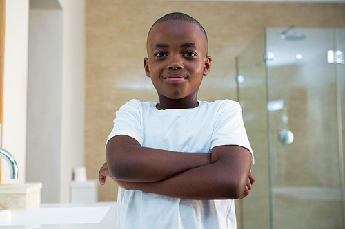 Portrait of smiling boy standing in domestic bathroom