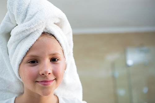 Portrait of girl with hair wrapped in towel bathroom