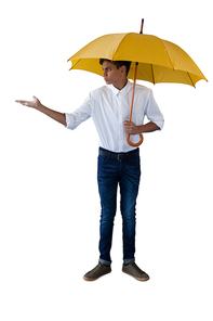 Boy standing under a yellow umbrella and gesturing