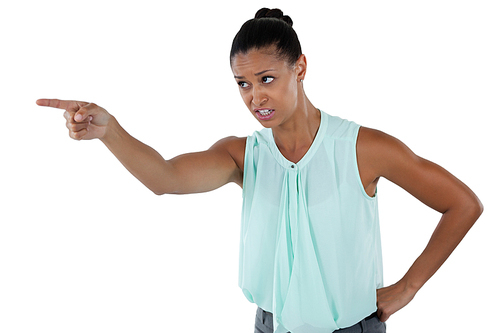 Angry businesswoman pointing against white background