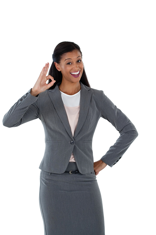 Smiling businesswoman gesturing okay hand sign