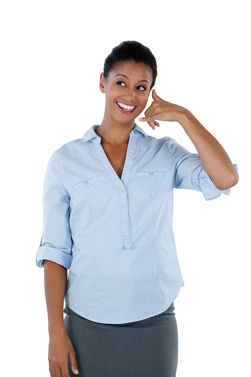 Businesswoman pretending to talk on a cell phone against white background