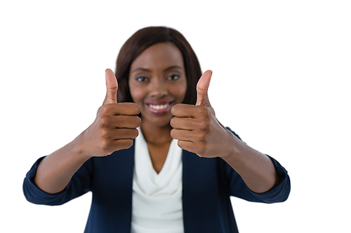 Woman showing thumbs up gesture against white background