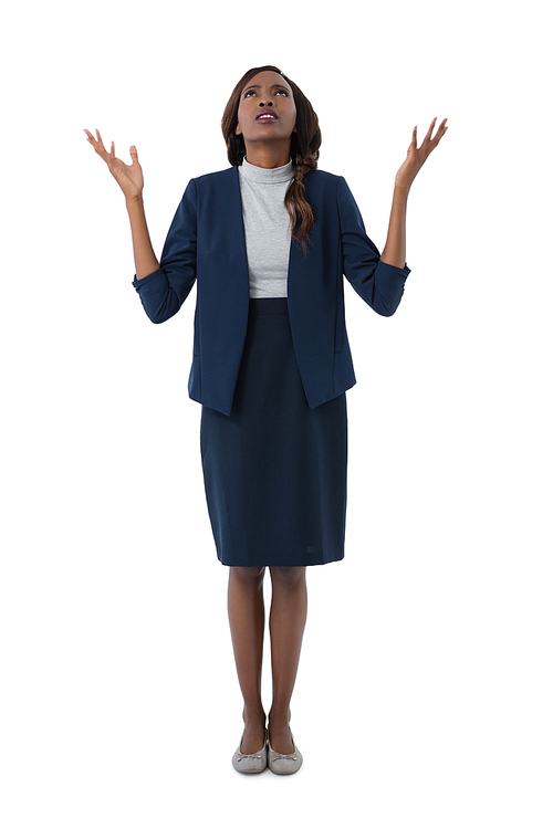 Full length of businesswoman looking up while standing against white background