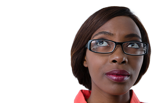 Close up up of woman with eyeglasses looking up against white background