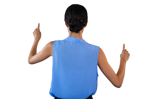 Rear view of businesswoman in sleeveless clothing pointing on interface against white background