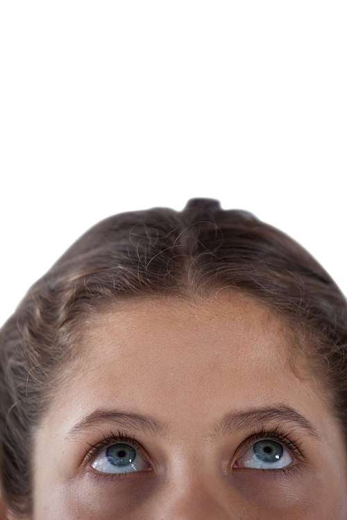 Close-up of girls eye and nose against white background