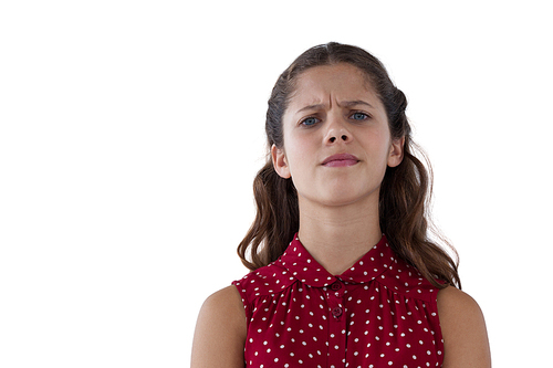 Confused teenage girl standing against white background