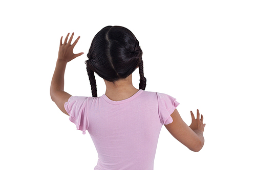 Rear view of girl pretending to touch an invisible screen against white background