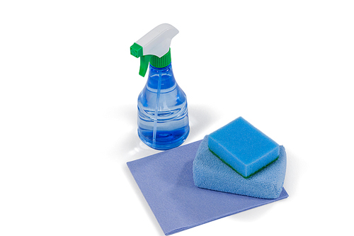 Close-up of spray bottle and scouring pad on white background