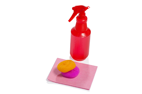 Spray bottle, scrubbers and cleaning pad arranged on white background