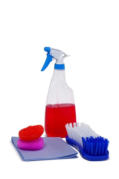 Detergent spray bottle, scrubber, napkin cloth and brush arranged on white background