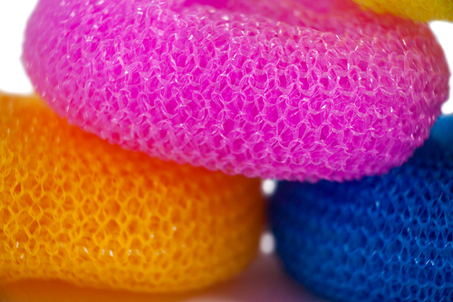 Close-up of various nylon scrubbers arranged on white background