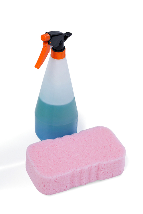 Detergent spray bottle and sponge pad arranged on white background
