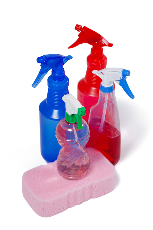 Various detergent spray bottle and sponge pad arranged on white background