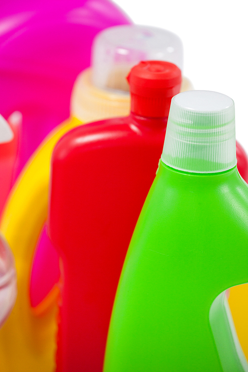 Close-up of various detergent containers arranged on white background