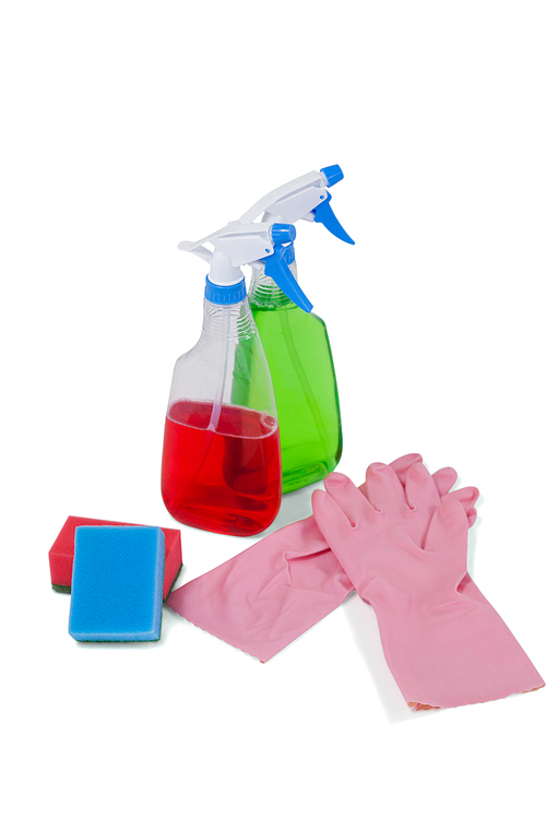 Detergent spray bottles, sponge pad and rubber glove arranged on white background